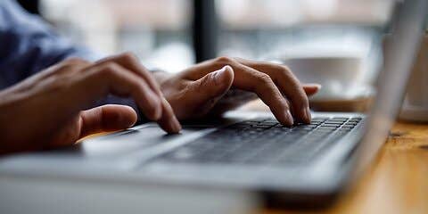 Person typing on laptop